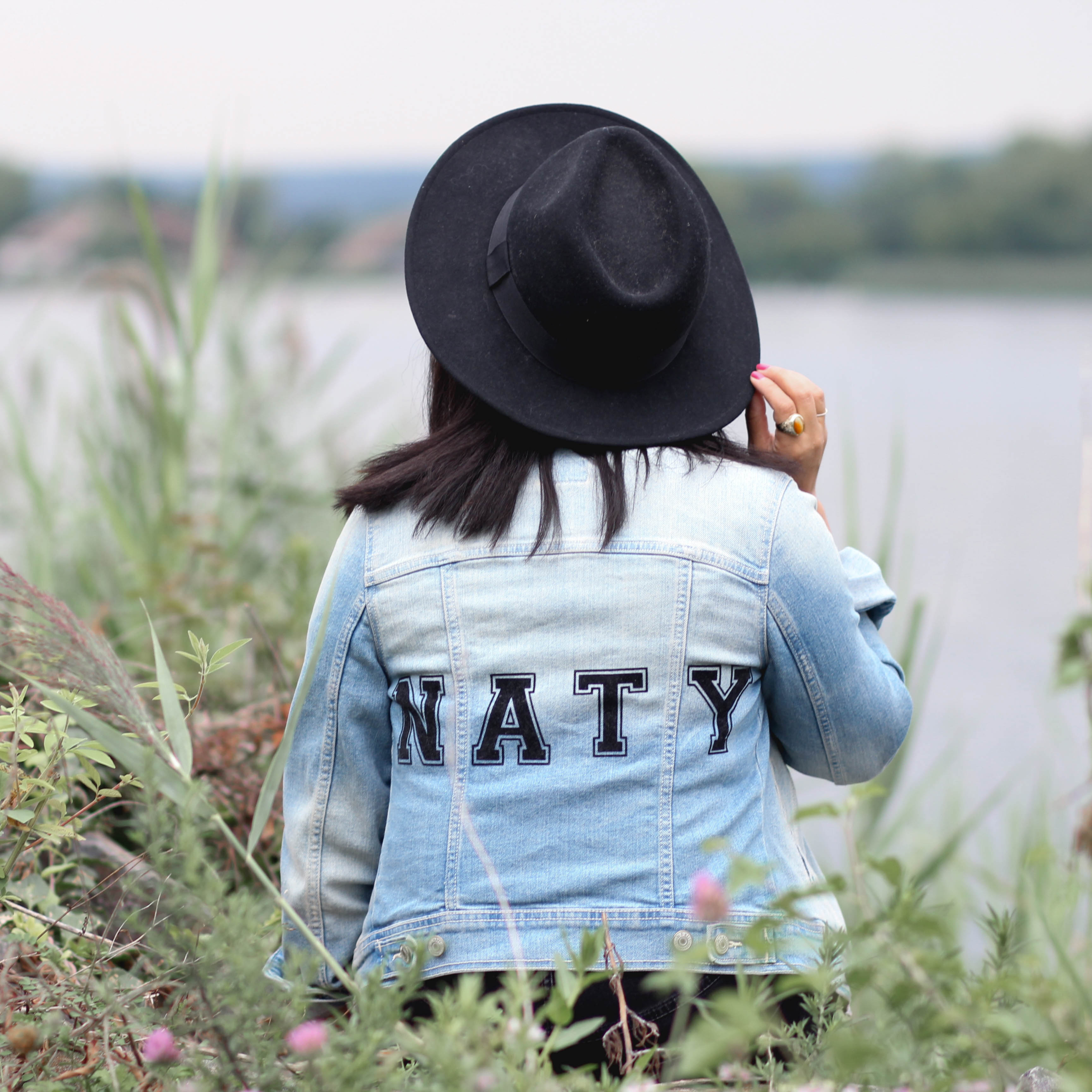 Lifestyle Blogger Naty Michele wearing a denim jacket and black hat