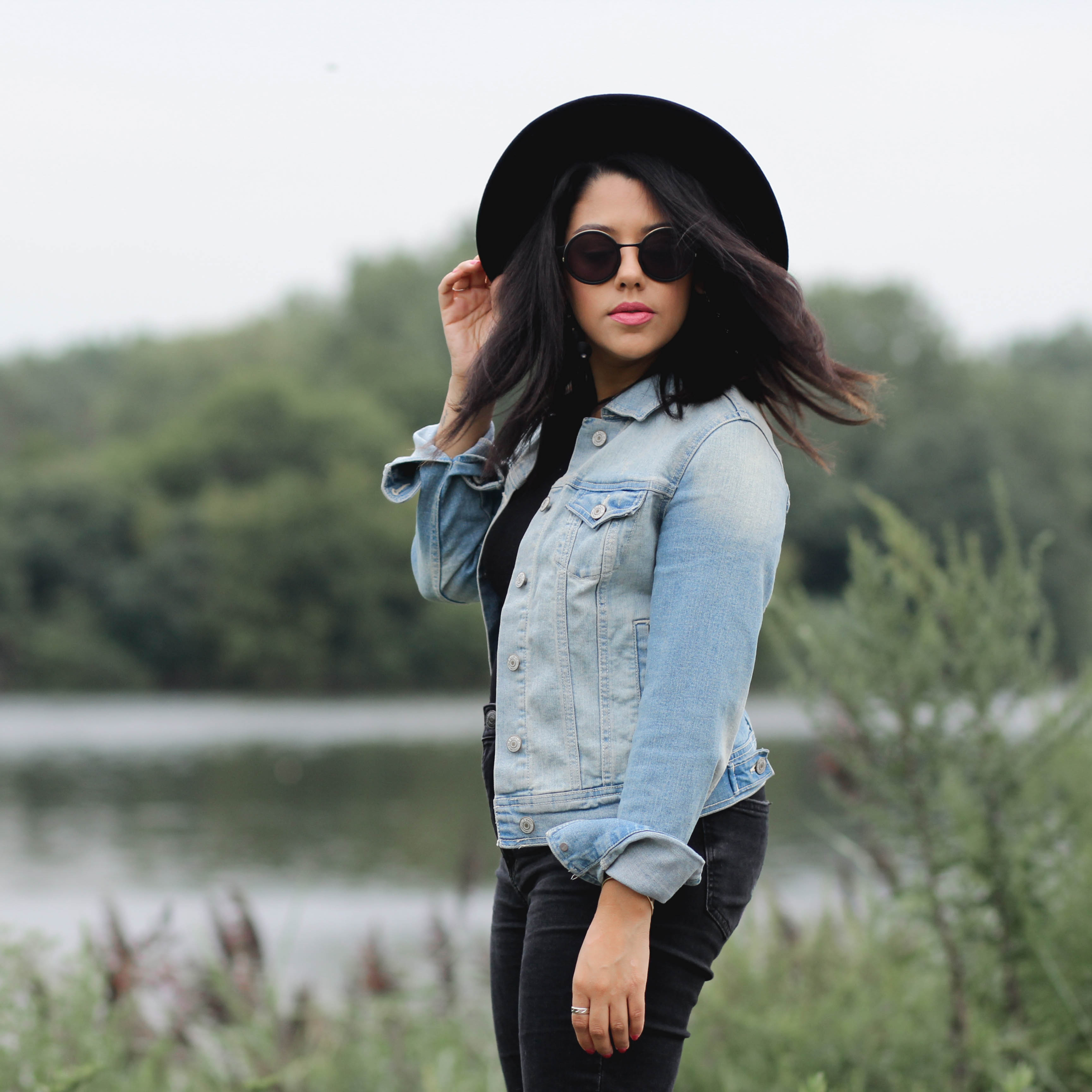 Lifestyle Blogger Naty Michele wearing a denim jacket with a black hat