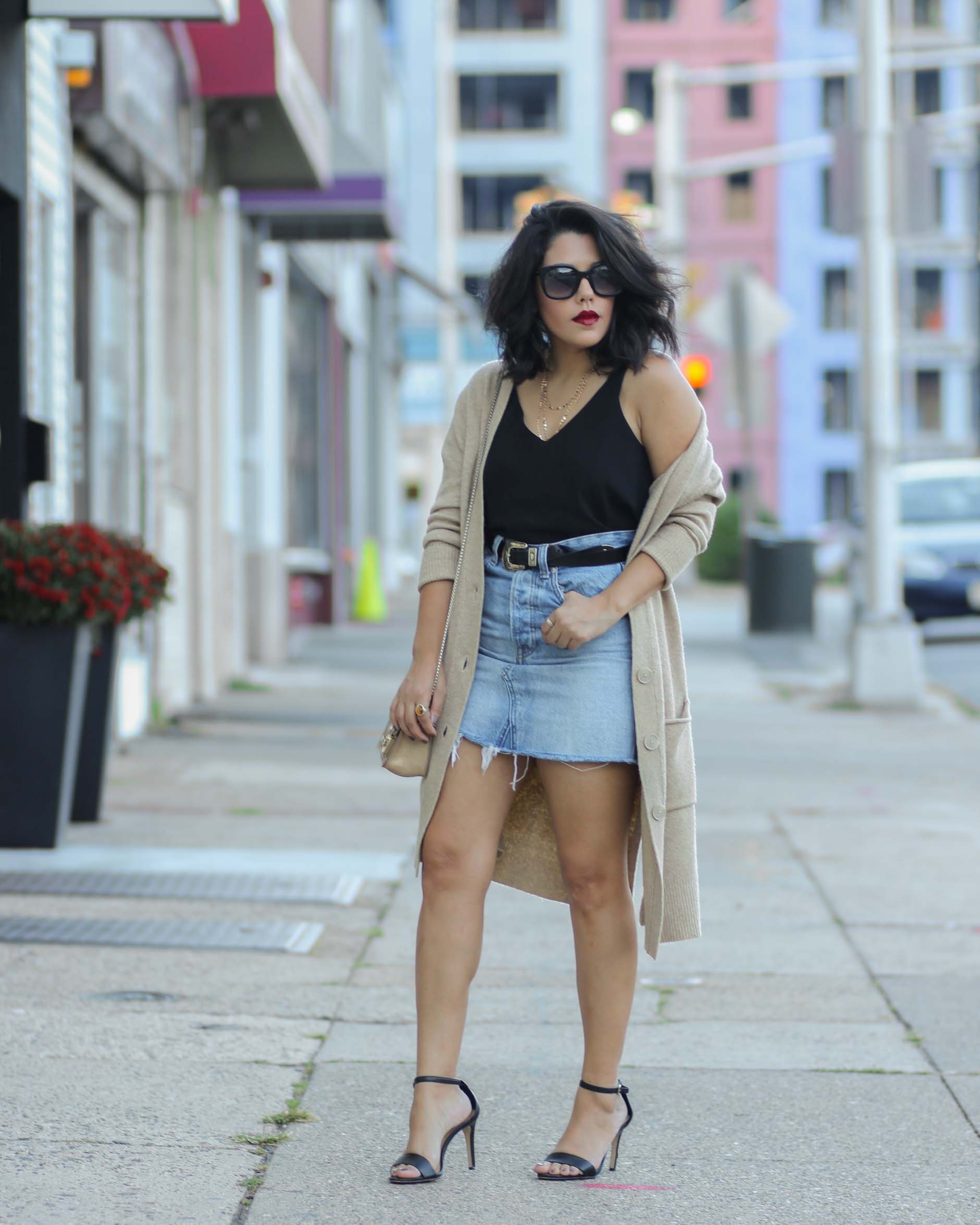 syle blogger naty michele wearing a denim skirt with oversized cardigan