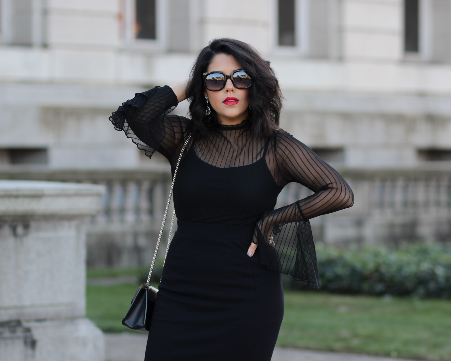 lifestyle blogger naty michele wearing sheer bell sleeve top from project runway