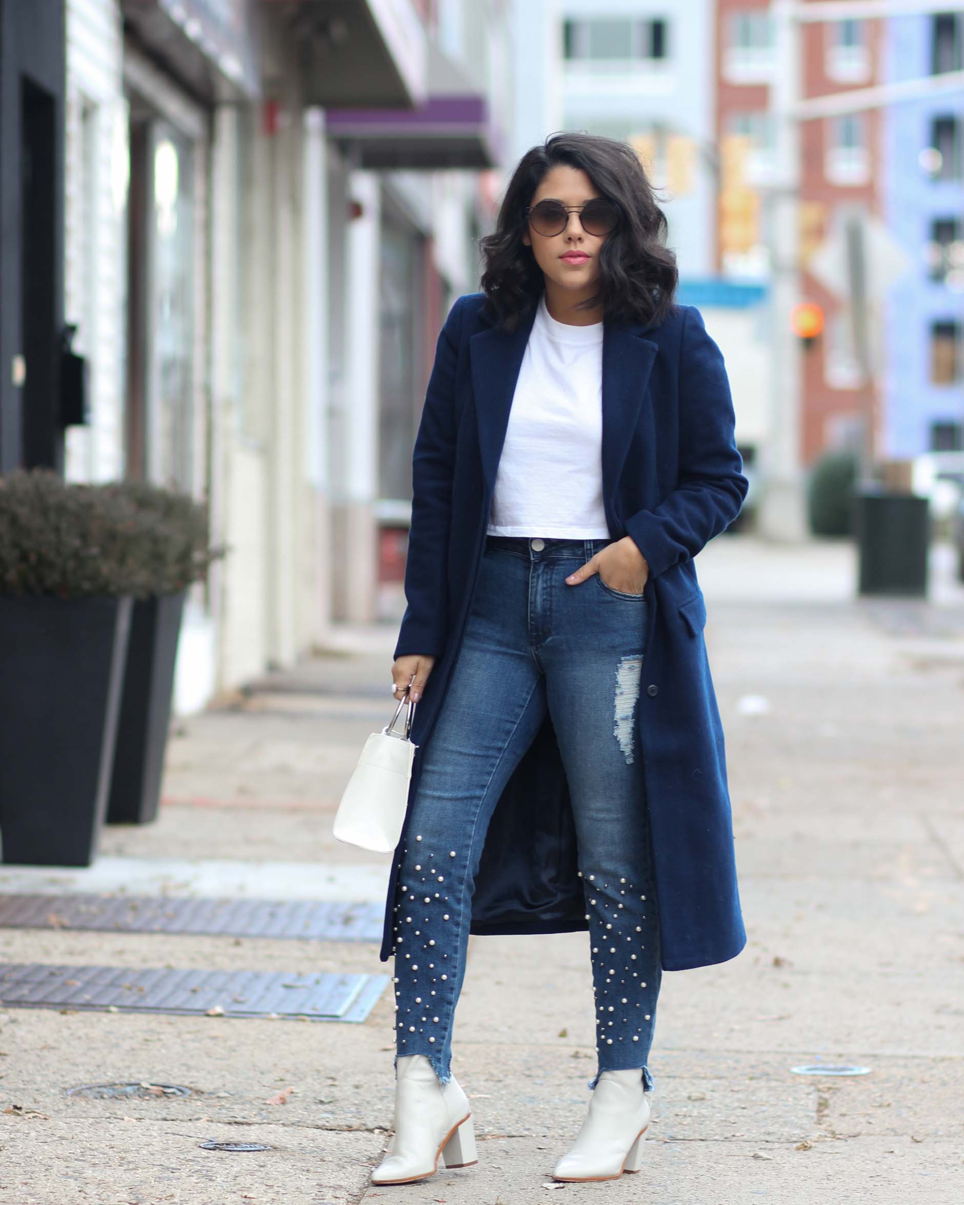 lifestyle blogger naty michele wearing pearl jeans and a navy coat