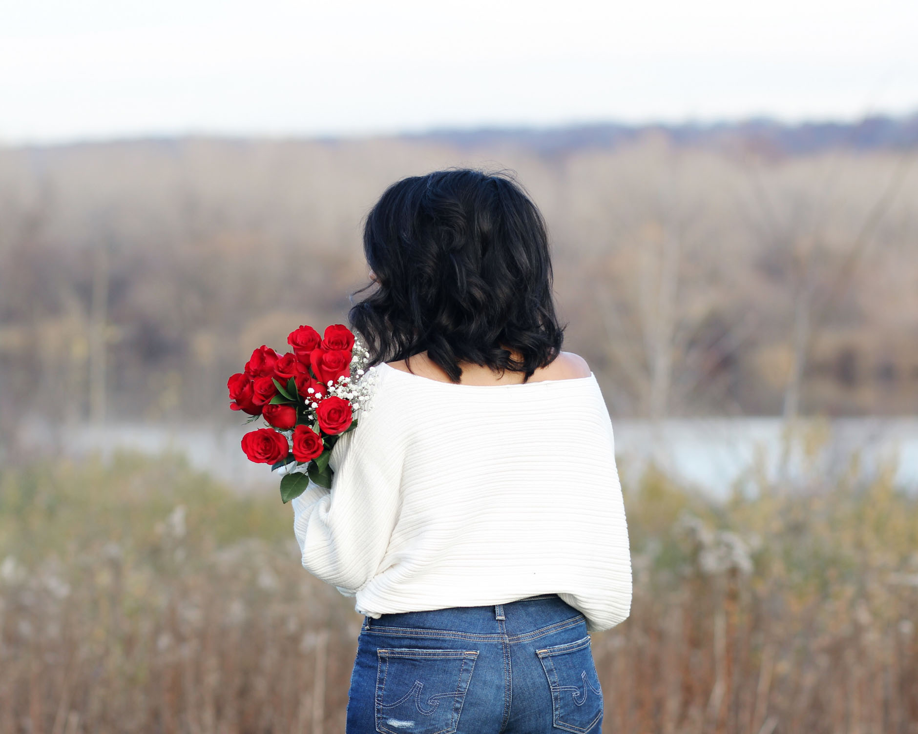 lifestyle blogger naty michele holding red roses 