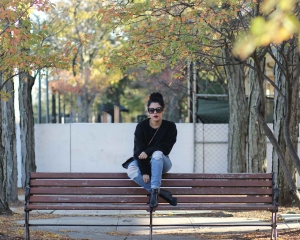 lifestyle blogger naty michele wearing a cropped black sweatshirt and denim