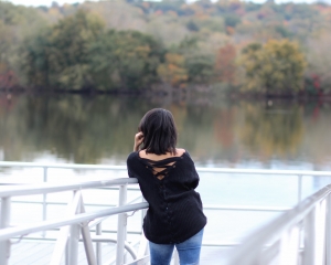 Lifestyle Blogger Naty Michele wearing a black back lace up sweater