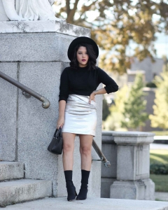 lifestyle blogger naty michele wearing a silver skirt with black sock boots