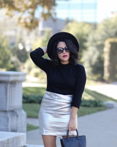 lifestyle blogger naty michele wearing a silver skirt and black sweater