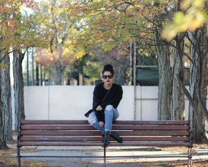 lifestyle blogger naty michele wearing a black cropped sweatshirt and denim