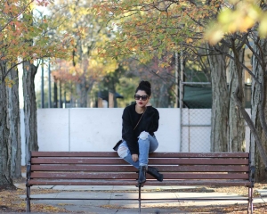 lifestyle blogger naty michele wearing a black cropped sweatshirt and denim