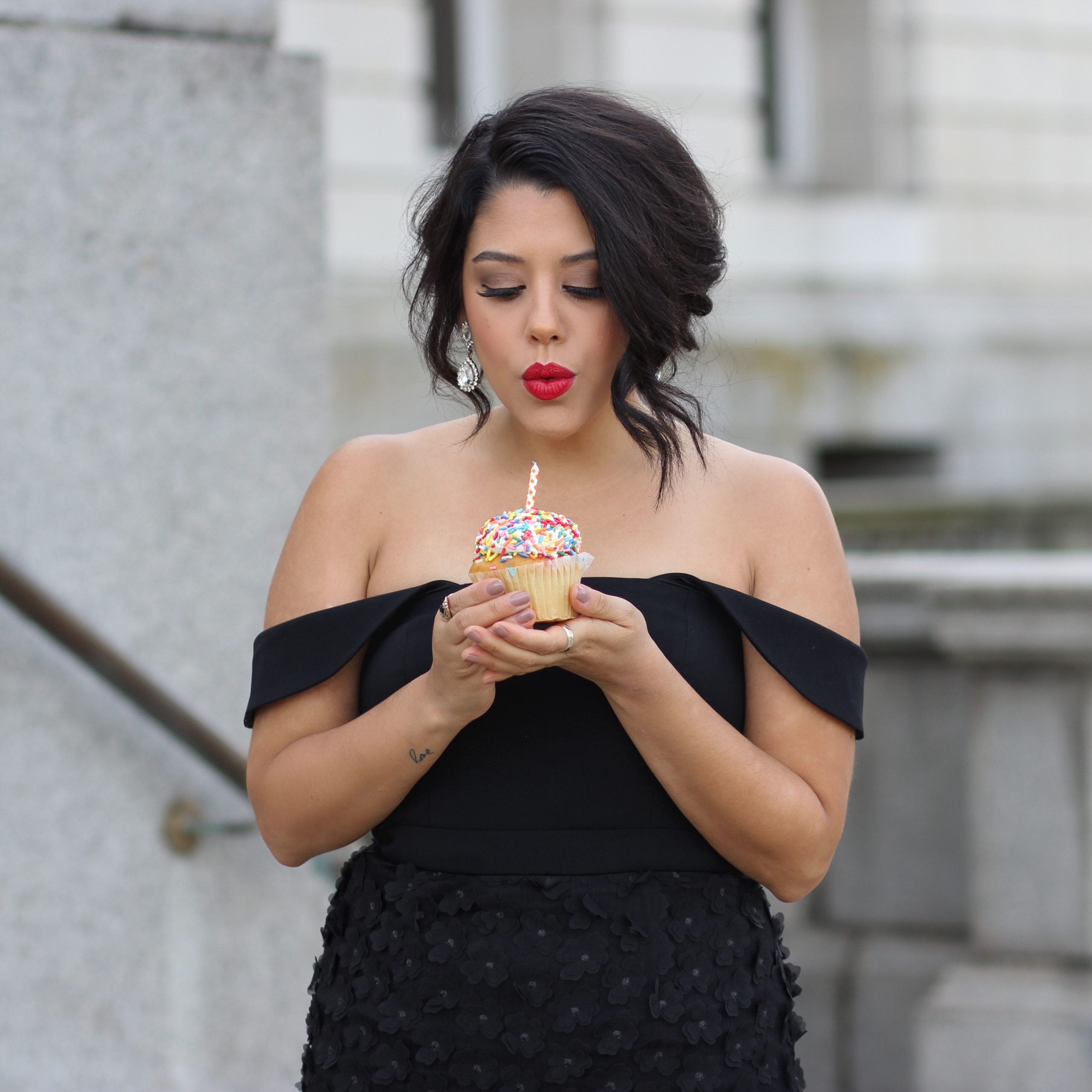 lifestyle blogger naty michele birthday blowing out cupcake 