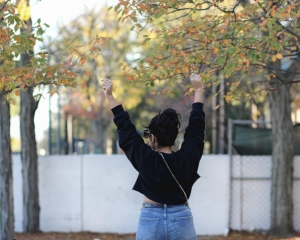 lifestyle blogger naty michele wearing a black cropped sweatshirt and denim