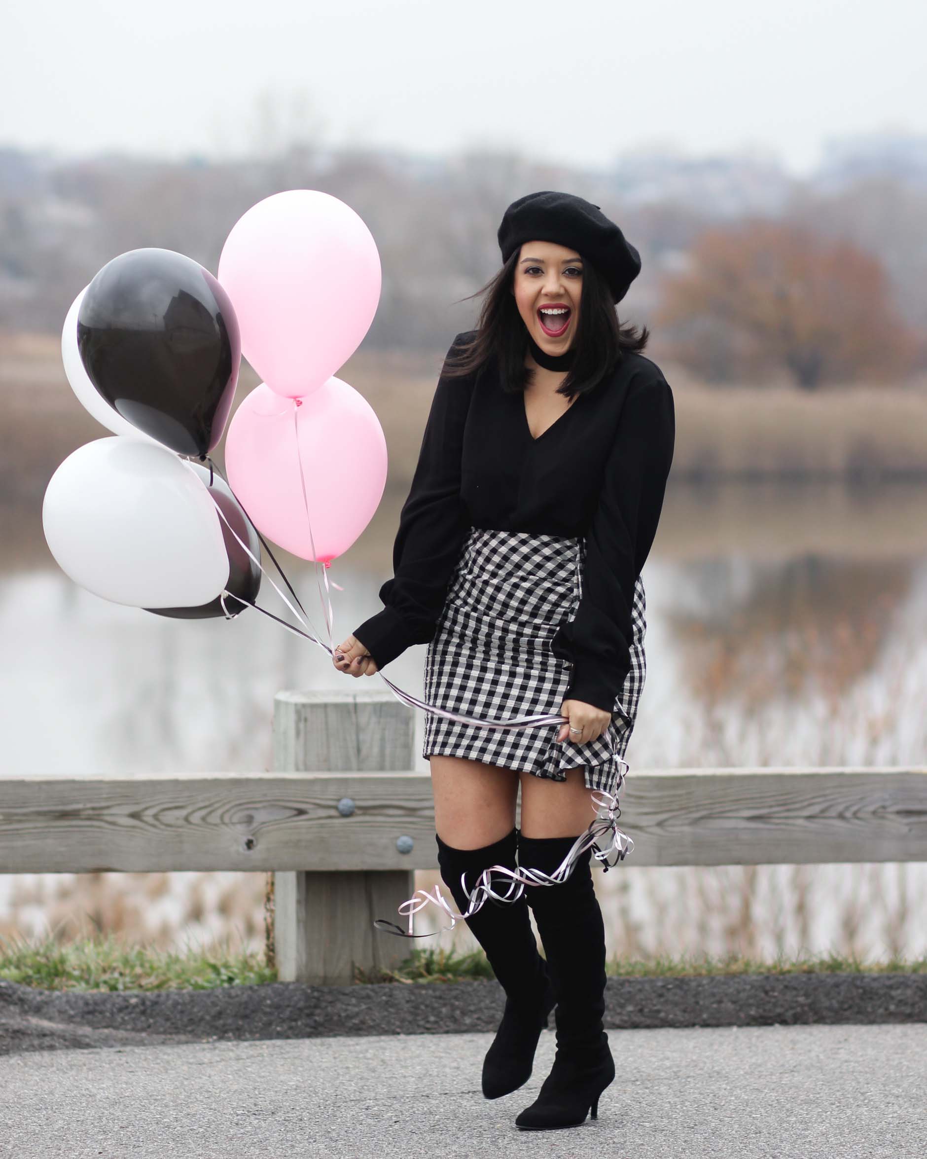 naty michele wearing beret and otk boots holding balloons