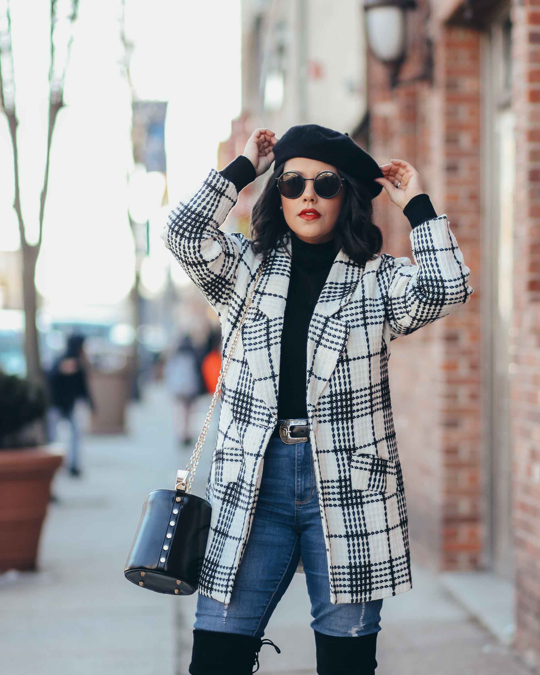 lifestyle blogger naty michele wearing a beret with a black and white coat and otk boots