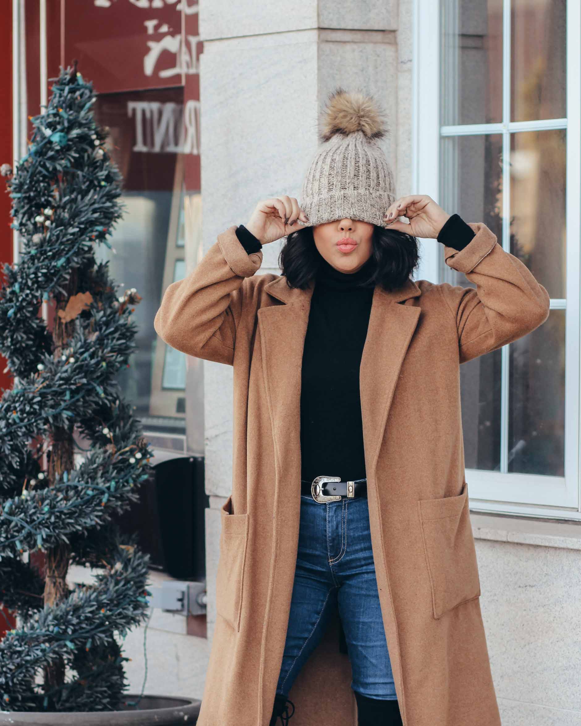 lifestyle blogger naty michele wearing pom beanie with camel coat