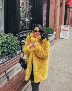 naty michele wearing yellow faux fur in new york city