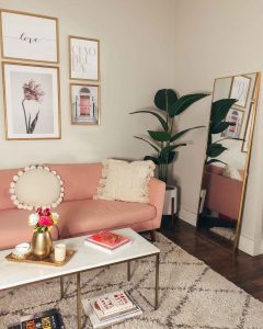 naty michele's studio apartment living room decor with a large mirror and faux plant